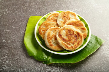 Stack of hot parathas with steam rising.