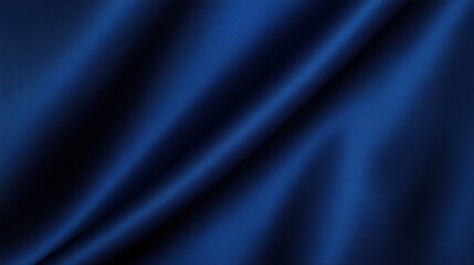 Obraz premium A smooth, deep blue fabric drapes elegantly, showcasing its rich texture and color.