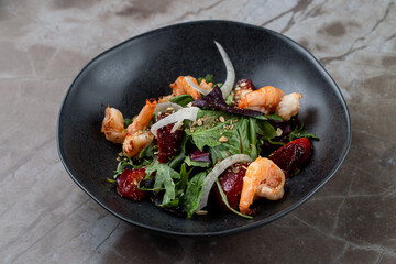 Fresh shrimp and vibrant greens come together beautifully in a colorful salad at a charming European restaurant, designed to tantalize taste buds on a lovely evening