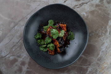 Deliciously prepared meat pieces coated in a savory sauce, beautifully presented with fresh cilantro, inviting guests to savor the elegant ambiance of the European restaurant during dinner