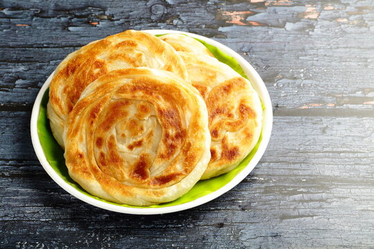 A sweet and savoury Kerala dish: warm and flaky porottas. 
