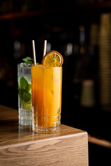 Enjoy a vibrant array of cocktails featuring bright colors and fresh garnishes, perfect for an evening at a charming European restaurant. The atmosphere invites relaxation and socializing