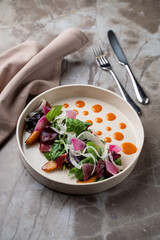 Savor the artistry of a beautifully presented gourmet salad crafted with fresh vegetables and delicate sauces