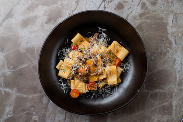 Savor the exquisite flavors of pasta adorned with a savory sauce and grated cheese, beautifully presented in a chic European dining setting, perfect for a culinary experience