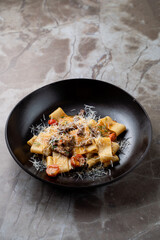 Delight in a beautifully crafted dish of pasta, topped with luscious sauce and a sprinkle of cheese, inviting guests to savor the finest European culinary experience