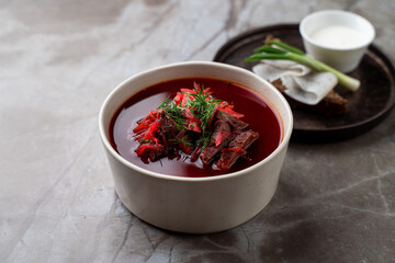 Savor the rich flavors of traditional borscht, featuring tender beef and vibrant beets, garnished with fresh herbs