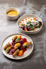 Diners savor beautifully plated dishes featuring vibrant colors and textures. Each plate displays meticulous preparation, highlighting fresh ingredients and artistic presentation