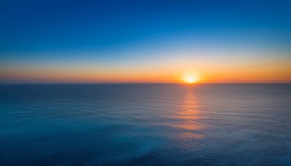 Obraz premium a serene gradient of colors blending softly from warm orange to cool blue capturing the beauty of a sunset over the horizon