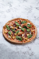 Savor the enticing flavors of a European cuisine pizza adorned with fresh spinach, ham, and creamy cheese, elegantly displayed on a polished marble table for a delightful dining experience