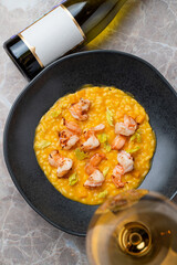 Savor a culinary delight with lobster risotto, bursting with fresh flavors and paired perfectly with crisp chardonnay in an elegant restaurant setting