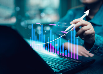 businessman hand type on the laptop of company profit with colleagues partner explain with virtual dashboard statistic chart stock infographic, graphs, cryptocurrency, and new trading platforms