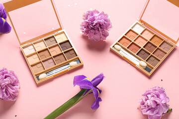 Eyeshadows palettes with flowers on pink background