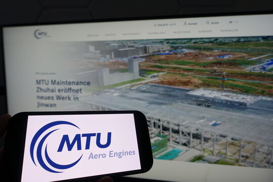Kiel, SH, Germany March 19 2025 Smartphone with the logo of MTU Aero Engines in front of a monitor showing their business website highlighting new developments