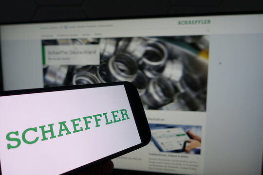 Kiel, SH, Germany - March 19 2025: Smartphone with the logo of Schaeffler in front of a monitor displaying their business website showcasing industrial solutions