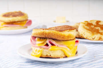Breakfast crumpet sandwich, british pancake scones burger with cheese and ham
