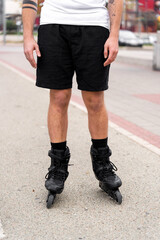 Young man wearing inline skates getting ready to ride in urban setting