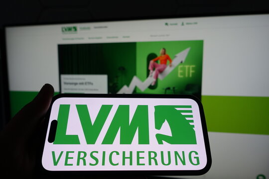 Kiel, SH, Germany - March 19 2025: Smartphone with the logo of LVM Versicherung in front of a monitor showcasing their business website with financial graphics