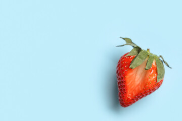 Fresh strawberry on blue background. Sex education
