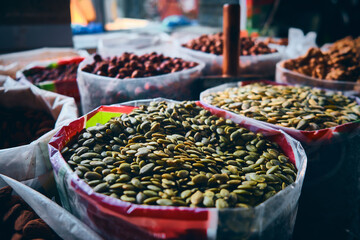 Heap of raw pumpkin seeds and other nuts and seeds at bazaar market