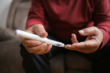 Person Hand And Blood Sugar With Finger For Diabetes Test At Home