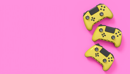 Realistic yellow video game joysticks or gamepads on pink background