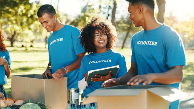 People, volunteer and boxes of charity at park for giving food, packing supplies and community aid. Staff, tablet and sorting products with donation outreach, teamwork and distribution of NGO welfare