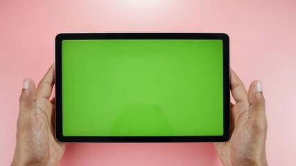 Big tab on the table with chromakey green screen on tablet