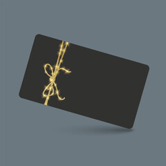 Black gift card with golden ribbon and bow