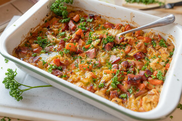 Rustic casserole with pork meat, pointed cabbage, carrots in a delicious cream sauce fresh and homemade cooked.