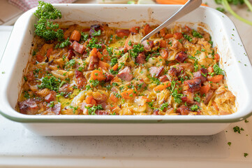 Rustic casserole with pork meat, pointed cabbage, carrots in a delicious cream sauce fresh and homemade cooked.
