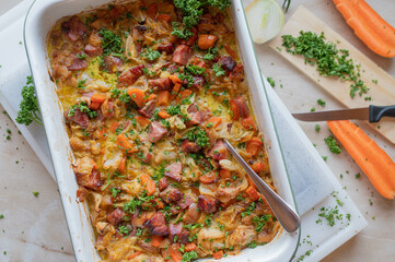 Rustic casserole with pork meat, pointed cabbage, carrots in a delicious cream sauce fresh and...