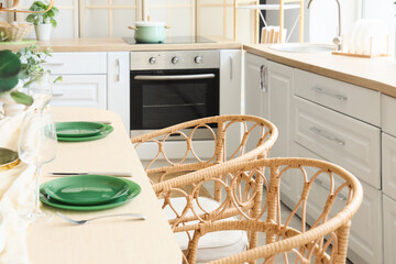 Interior of modern stylish kitchen with served dining table