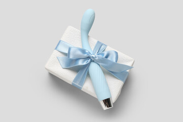 Sex toy and gift box on grey background