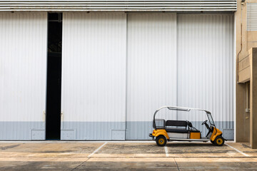 Yellow golf carts parked in front of the building to provide service to users.