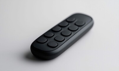 Isolated on a white surface is a sleek, black remote control with round buttons, ideal for home entertainment.