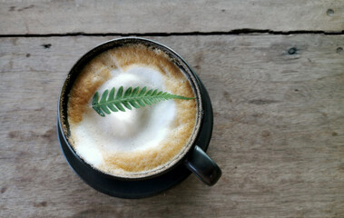 Coffee in a glass and fern leaves