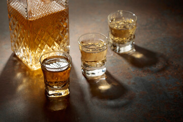 Decanter and small glasses of whiskey.