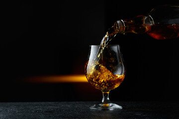 Brandy being poured into a glass.