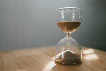 Hourglass with sand running out, symbolizing passing time, time, clock, sand, symbol, concept, running out, hour 

