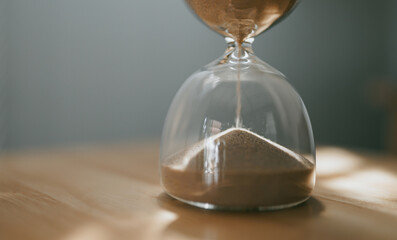 Hourglass with sand running out, symbolizing passing time, time, clock, sand, symbol, concept,...