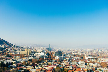 Top view of a large city in a gorge. Megapolis in the mountains. Top view of many buildings. Georgia. Tbilisi