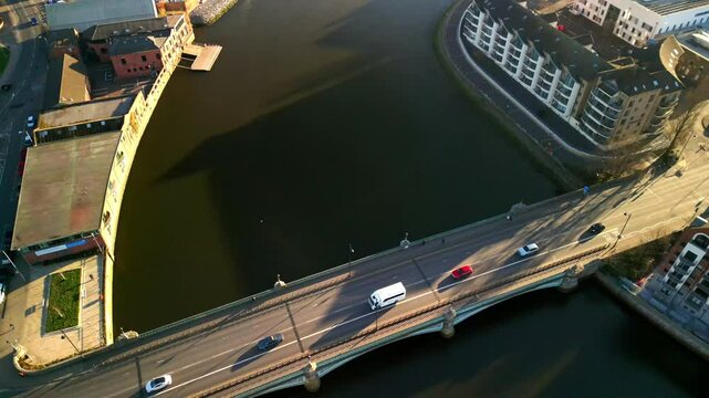 Descending aerial of Queen's Bridge and the River Lagan in Belfast, Northern Ireland on a sunny day. Filmed in 4K, 60FPS with Rec709 color.