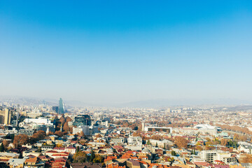 Top view of a large city in a gorge. Megapolis in the mountains. Top view of many buildings. Georgia. Tbilisi