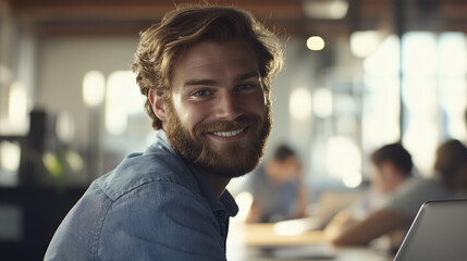 Smiling Young Professional Working on Laptop in a Cozy Cafe