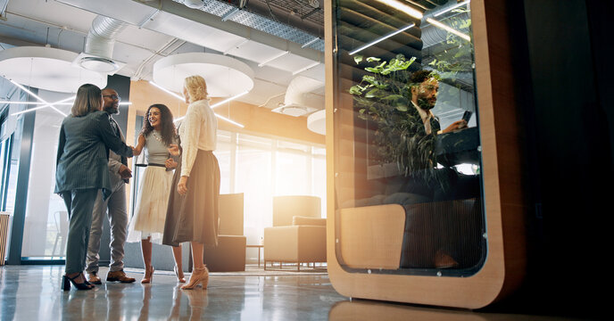 Lobby, corporate and business people with cubicle in office for coworking space for collaboration, teamwork and meeting. Professional, discussion and men and women in workspace pods for productivity
