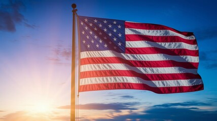The American flag is waving in the blue sky. The American flag waving proudly against a backdrop of a warm sunset sky