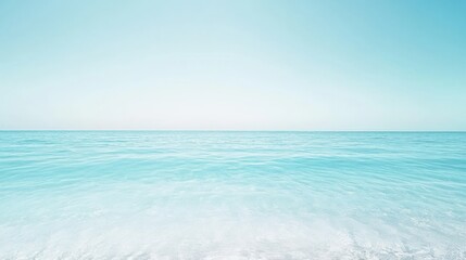 Fototapeta premium Serene ocean landscape with crystal clear turquoise water and a soft gradient from white sand to a calm blue sky