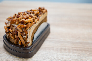 Caramel Almond Toffee Cake. Brown needle coffee cake in a separate container on a wooden table