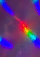 The image features an abstract, colorful texture with a holographic or iridescent effect. The...