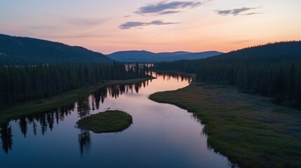 Fototapeta premium Serene river winding through lush forested landscape at sunset